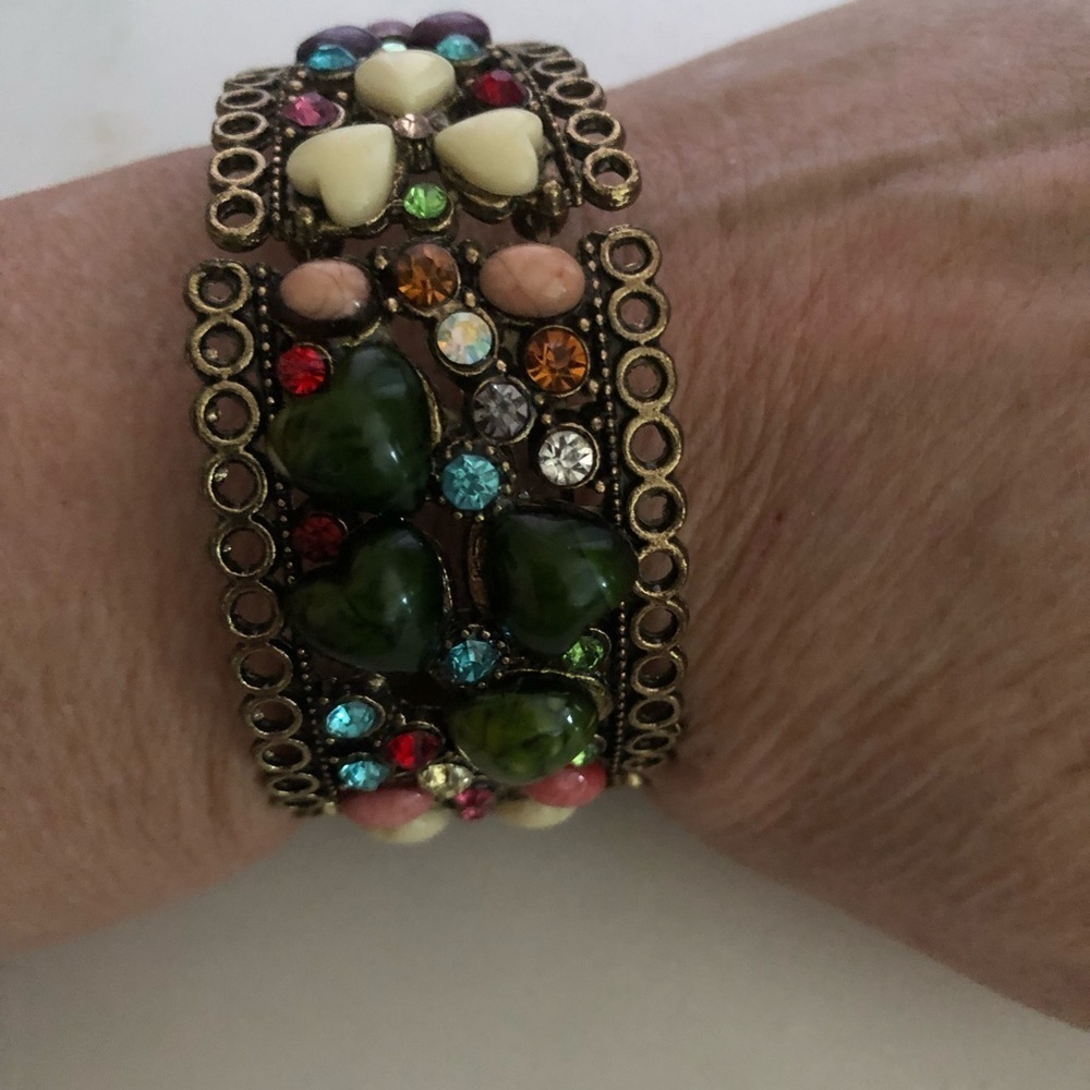 Colorful boho style rhinestones and colourful stones embedded in a gold metal.
